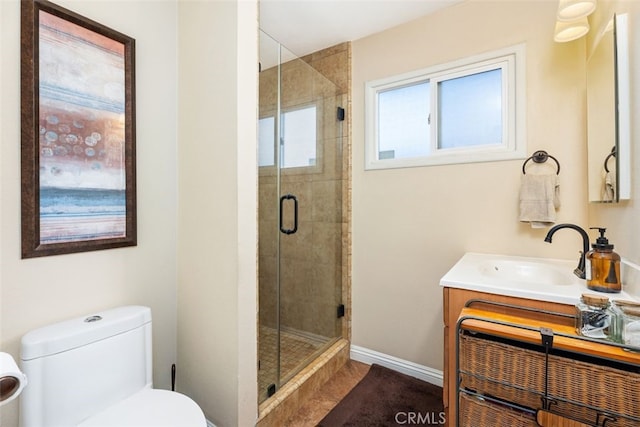 bathroom featuring vanity, toilet, and an enclosed shower