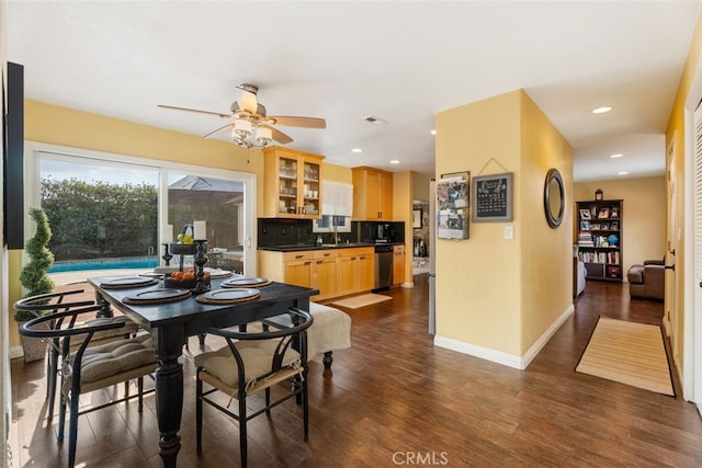 dining room with dark hardwood / wood-style floors and ceiling fan