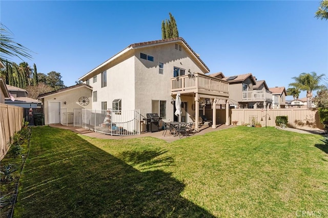 rear view of house featuring cooling unit, a yard, a patio, and a balcony