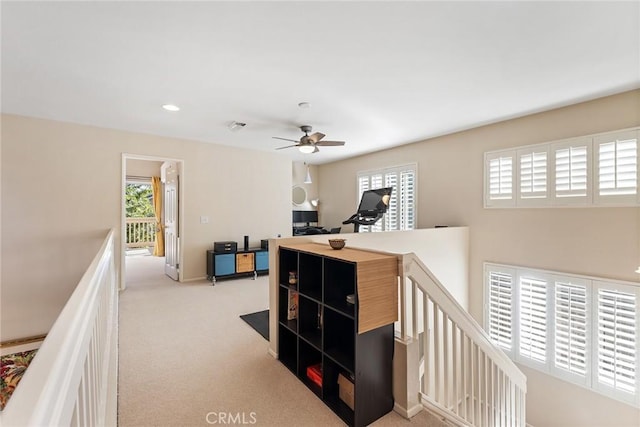 hallway with light colored carpet