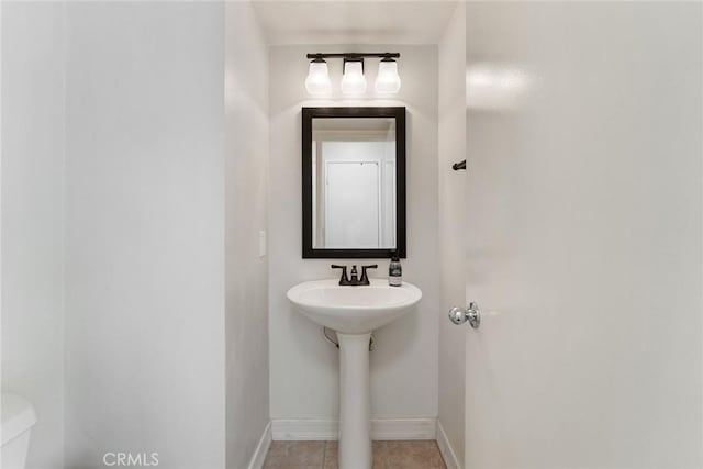 bathroom with tile patterned flooring, sink, and toilet