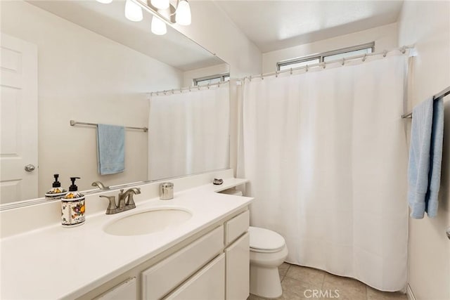 bathroom with vanity, tile patterned floors, and toilet