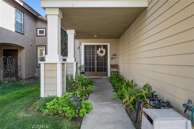 doorway to property with a lawn