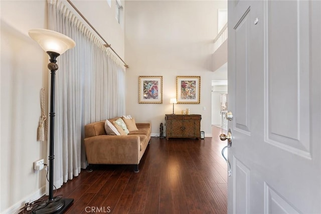 entryway featuring a high ceiling and dark hardwood / wood-style floors