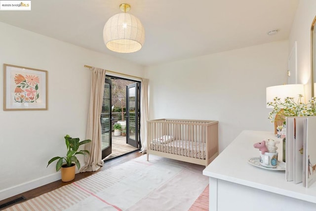 bedroom with hardwood / wood-style flooring and access to exterior