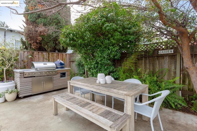 view of patio featuring area for grilling and a grill