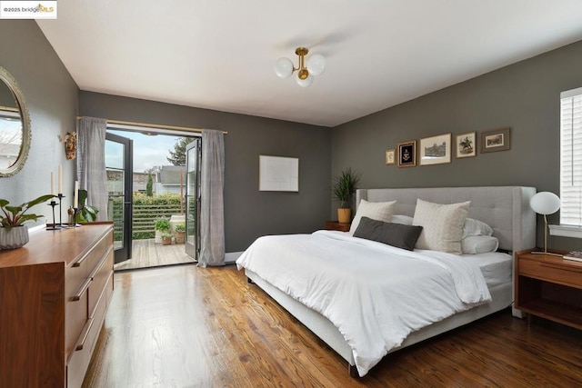 bedroom with access to exterior and hardwood / wood-style floors