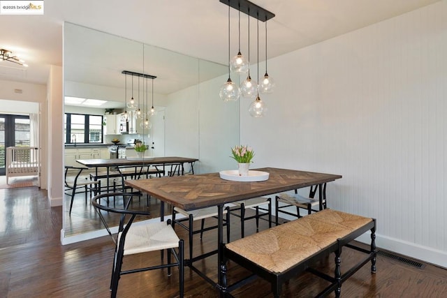 dining space with sink, dark hardwood / wood-style flooring, and french doors