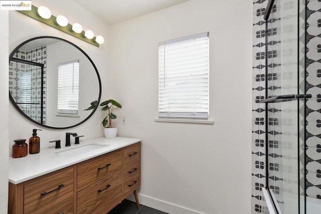 bathroom featuring vanity and a shower with shower door