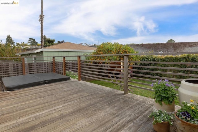 deck with a covered hot tub