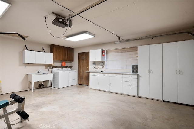 garage with washer and clothes dryer, a sink, and a garage door opener