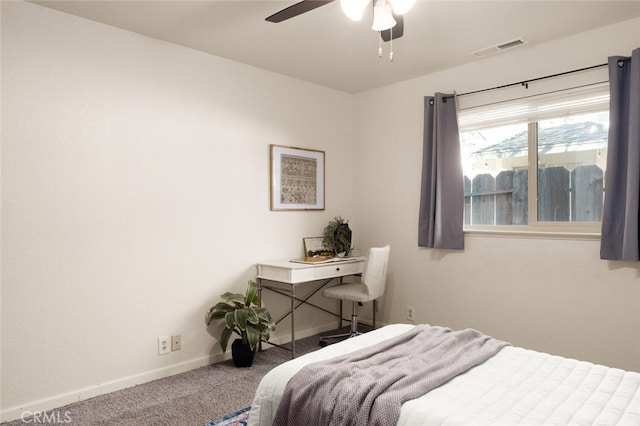 carpeted bedroom featuring ceiling fan, visible vents, and baseboards