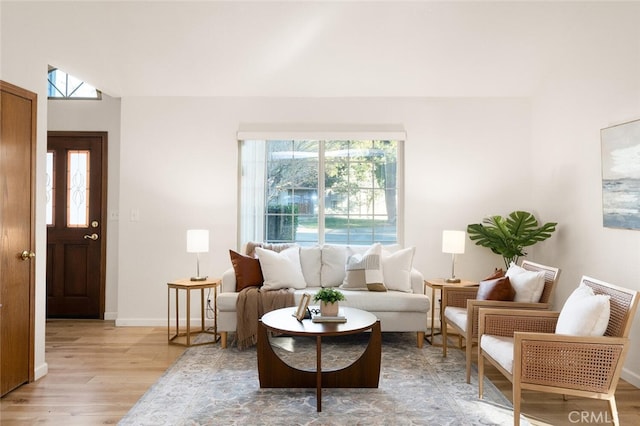 living area featuring light wood-style flooring and baseboards