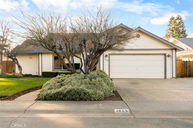 ranch-style home featuring a garage and a front lawn