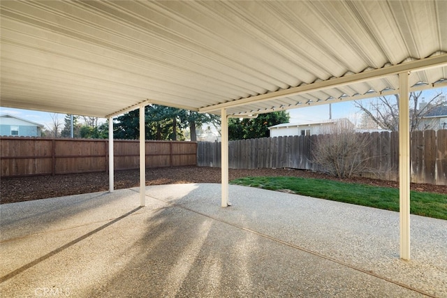 view of patio / terrace featuring a carport and a fenced backyard