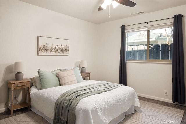 bedroom with a ceiling fan, light carpet, visible vents, and baseboards