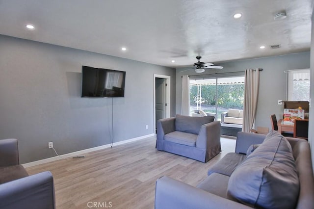 living room with ceiling fan and light wood-type flooring