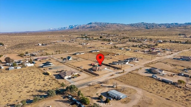 birds eye view of property with a mountain view