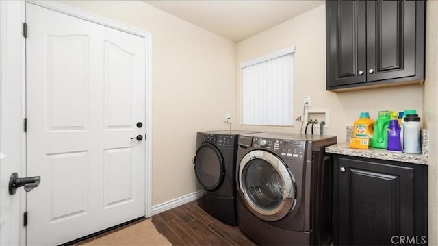 clothes washing area with cabinets and washer and clothes dryer