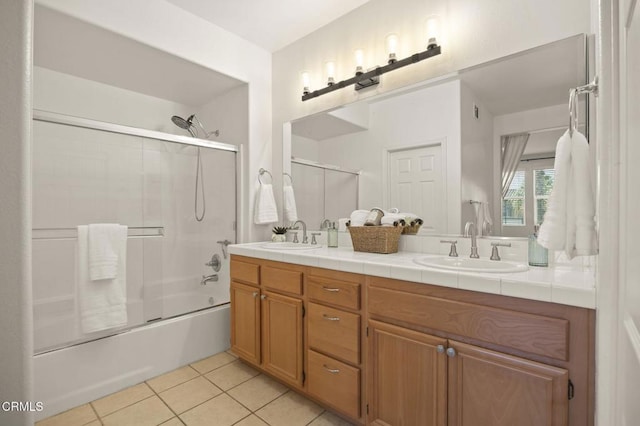 bathroom with vanity, shower / bath combination with glass door, and tile patterned flooring