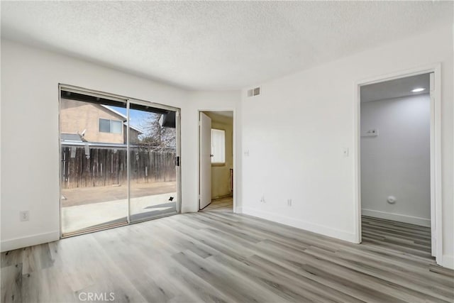 13031 Eyota Dr, Moreno Valley, CA 92555 - unfurnished room featuring a textured ceiling, wood finished floors, and baseboards