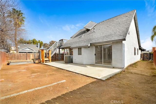 13031 Eyota Dr, Moreno Valley, CA 92555 - rear view of property featuring roof with shingles, a fenced backyard, stucco siding, a patio, and cooling unit