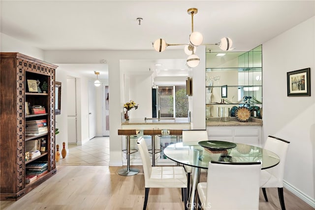 dining room featuring sink and light hardwood / wood-style floors