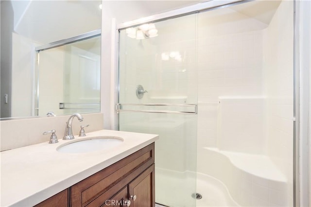 bathroom with walk in shower and vanity