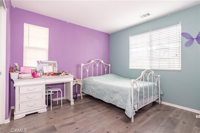 bedroom with hardwood / wood-style flooring