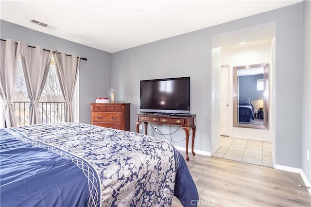 bedroom featuring light hardwood / wood-style flooring and access to outside