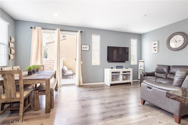 living room with plenty of natural light and wood-type flooring