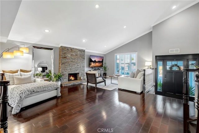 interior space featuring crown molding, dark hardwood / wood-style flooring, high vaulted ceiling, and a stone fireplace