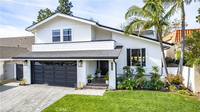 view of front of home featuring a garage and a front lawn