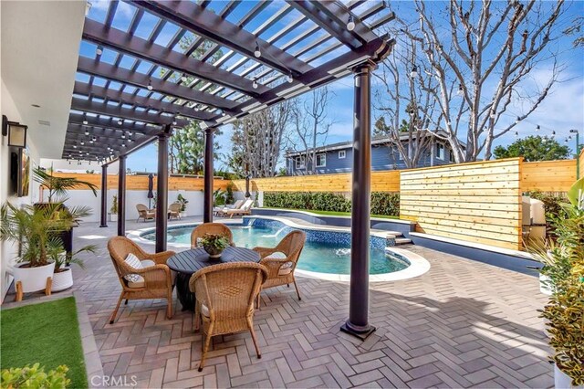 view of pool featuring pool water feature, a pergola, and a patio