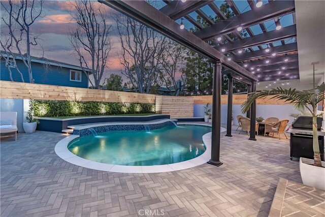 pool at dusk featuring a pergola, a jacuzzi, grilling area, and a patio area