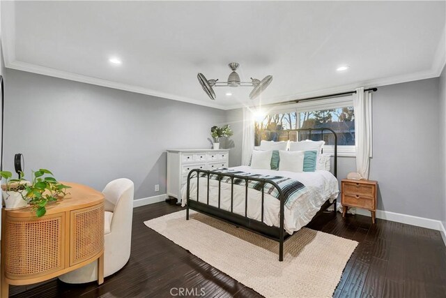 bedroom with crown molding, ceiling fan, and dark hardwood / wood-style flooring