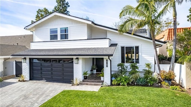 view of front of property with a garage and a front yard