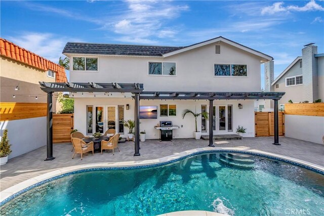 back of property featuring a pergola and a patio area