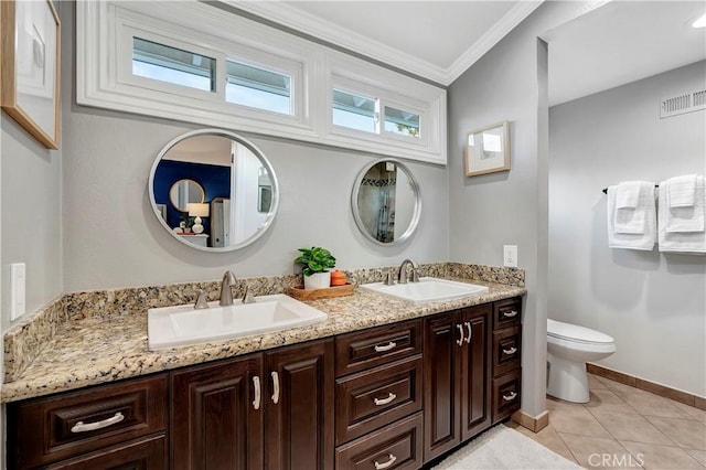 bathroom featuring tile patterned flooring, vanity, ornamental molding, and toilet