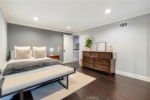 bedroom featuring ornamental molding and dark hardwood / wood-style floors