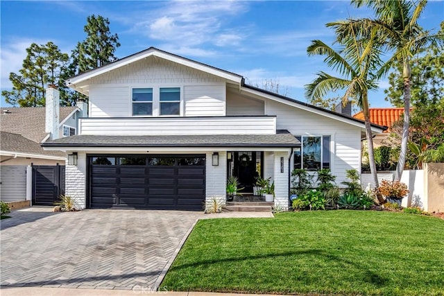 view of front of home featuring a garage and a front lawn