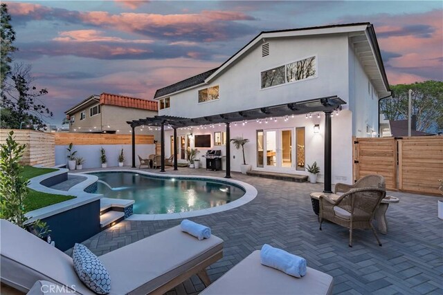 back house at dusk featuring a fenced in pool, a patio, french doors, and a pergola