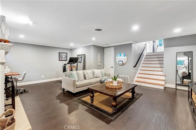 living room featuring crown molding and dark hardwood / wood-style floors