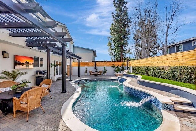 view of pool featuring pool water feature, a patio area, and a pergola