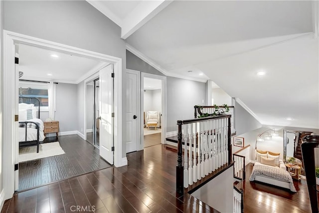 hall with lofted ceiling, crown molding, and dark hardwood / wood-style floors