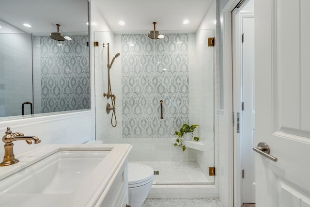 bathroom featuring vanity, toilet, and a shower with shower door