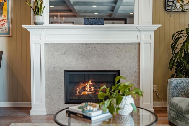 interior details with hardwood / wood-style flooring, a fireplace, and wooden walls