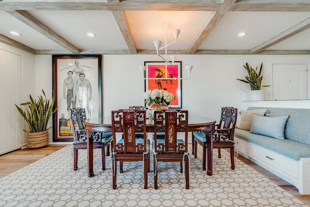 dining area featuring beamed ceiling and wood-type flooring