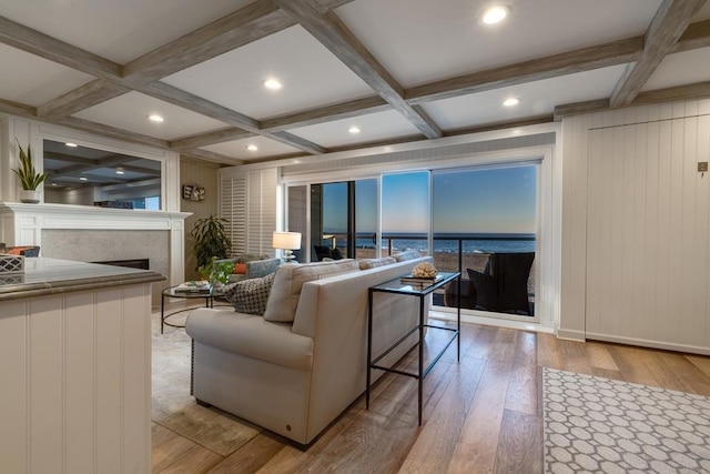 living room with coffered ceiling, beam ceiling, and light hardwood / wood-style flooring