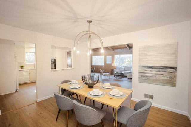 dining area featuring sink and light wood-type flooring